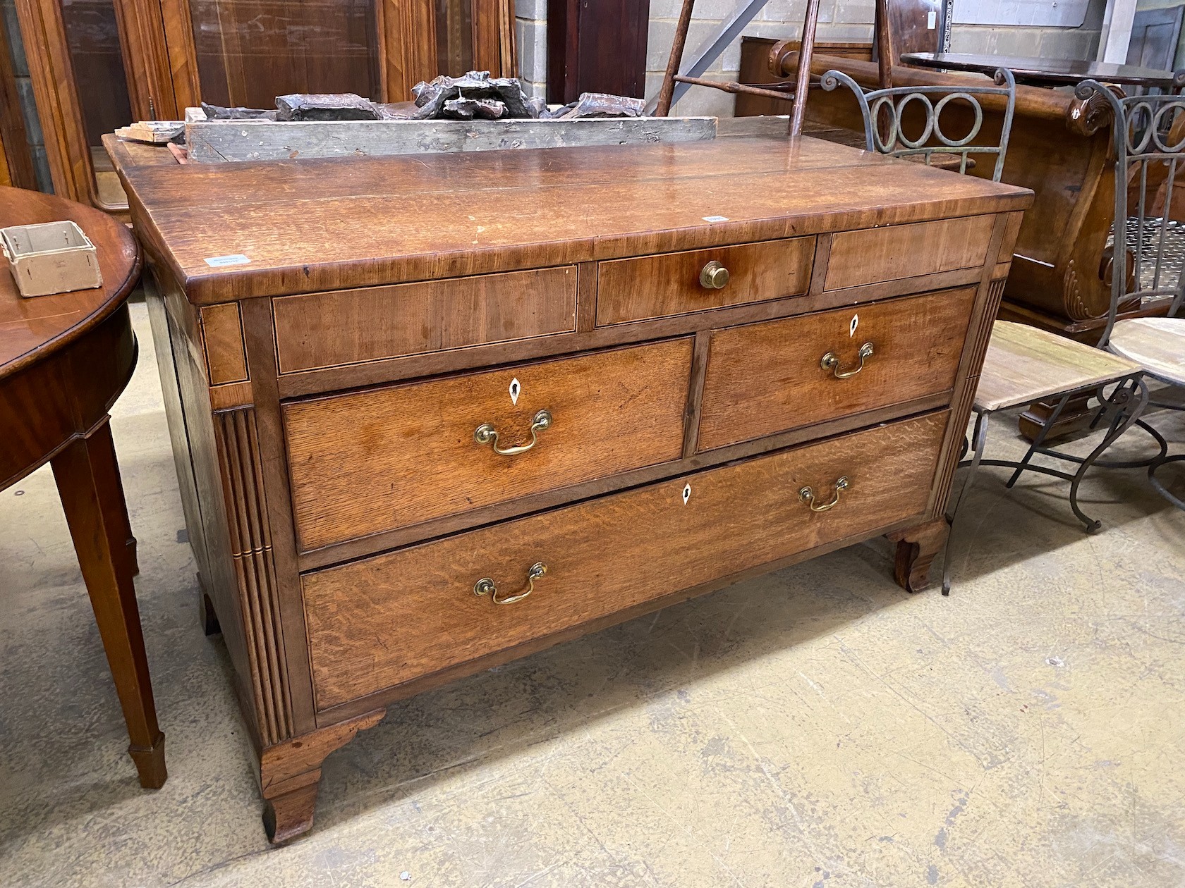 A George III oak and mahogany four drawer low chest, altered, width 133cm, depth 56cm, height 82cm